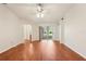 Unfurnished living room with wood flooring, slider to patio, and open doorway to bathroom at 10150 Heather Sound Dr, Tampa, FL 33647