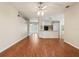 Open-concept living space with wood floors, neutral paint, and a view into the kitchen and breakfast bar at 10150 Heather Sound Dr, Tampa, FL 33647