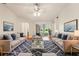 Staged living room with wood floors, plenty of natural light, and stylish decor at 10150 Heather Sound Dr, Tampa, FL 33647
