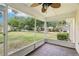 Screened-in porch featuring tile flooring, a ceiling fan and an open view of the front yard at 10150 Heather Sound Dr, Tampa, FL 33647