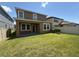 This backyard features a well-maintained lawn, a covered patio, and a privacy fence at 1022 Oliveto Verdi Ct, Brandon, FL 33511