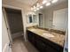 A bathroom with double sinks, granite counters, modern fixtures, and ample lighting at 1022 Oliveto Verdi Ct, Brandon, FL 33511