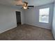 Bedroom with carpet flooring, ceiling fan, and window with natural light at 1022 Oliveto Verdi Ct, Brandon, FL 33511