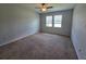Spacious bedroom featuring neutral carpeting, neutral walls, and natural light from two windows at 1022 Oliveto Verdi Ct, Brandon, FL 33511