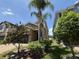 Eye-level front exterior shows stone accents and palm trees in the landscaped yard at 1022 Oliveto Verdi Ct, Brandon, FL 33511