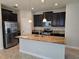 Modern kitchen with stainless steel appliances, granite countertops, and dark wood cabinetry at 1022 Oliveto Verdi Ct, Brandon, FL 33511