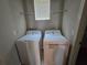 Functional laundry area featuring a washer, dryer, and shelving, maximizing space and organization at 1022 Oliveto Verdi Ct, Brandon, FL 33511