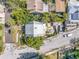Aerial view of property showcasing lush landscaping and proximity to neighboring homes, highlighting its peaceful location at 1038 Crescent Lake N Dr, St Petersburg, FL 33701