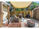 Inviting backyard patio features a grill, shade cover, comfortable seating, and a fire pit, perfect for outdoor relaxation at 1038 Crescent Lake N Dr, St Petersburg, FL 33701