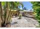 Expansive backyard featuring a patio, storage shed, hammock, and lush landscaping, perfect for outdoor enjoyment at 1038 Crescent Lake N Dr, St Petersburg, FL 33701