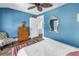 Bedroom with bright blue walls, closet, and wooden dresser at 1038 Crescent Lake N Dr, St Petersburg, FL 33701