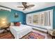 Brightly painted bedroom with a large window, ceiling fan, and hardwood flooring at 1038 Crescent Lake N Dr, St Petersburg, FL 33701