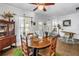 Bright dining area featuring a unique live edge wood table, complemented by vintage furnishings and ample natural light at 1038 Crescent Lake N Dr, St Petersburg, FL 33701