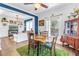 Well-lit dining room with open layout, adjacent to the living room, featuring a natural wood table at 1038 Crescent Lake N Dr, St Petersburg, FL 33701
