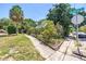 Landscaped home exterior with manicured lawn, mature trees, and welcoming curb appeal on a corner lot at 1038 Crescent Lake N Dr, St Petersburg, FL 33701