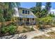 Charming two-story home with a metal roof, a quaint front yard, and a picket fence at 1038 Crescent Lake N Dr, St Petersburg, FL 33701