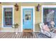 Welcoming front porch with outdoor seating, blue trim, and a blue front door with glass at 1038 Crescent Lake N Dr, St Petersburg, FL 33701