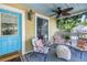Relaxing front porch with comfortable seating, a ceiling fan, and a decorative blue area rug at 1038 Crescent Lake N Dr, St Petersburg, FL 33701