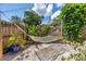 Serene backyard featuring a comfortable hammock surrounded by lush greenery and a wooden fence at 1038 Crescent Lake N Dr, St Petersburg, FL 33701