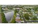 An aerial view of a home with a pond, mature trees, and a well-maintained neighborhood at 10430 42Nd N St, Clearwater, FL 33762