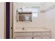 Bathroom featuring vanity, toilet, medicine cabinet with mirrors, shower with a glass door, and natural light at 10430 42Nd N St, Clearwater, FL 33762