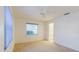Bright bedroom with neutral carpet, ceiling fan, window, and access to an ensuite bathroom at 10430 42Nd N St, Clearwater, FL 33762