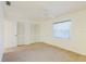 Neutral bedroom with carpet, window with blinds, and a closet with bi-fold doors at 10430 42Nd N St, Clearwater, FL 33762
