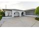 A charming single-story home with arched entryways, a well-maintained driveway, and mature landscaping at 10430 42Nd N St, Clearwater, FL 33762