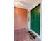 A front porch featuring a brick wall, a ceiling fan, a welcome mat, and a green front door at 10430 42Nd N St, Clearwater, FL 33762