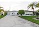 Attractive single-story home with a well-maintained lawn, mature tree, and appealing architectural details at 10430 42Nd N St, Clearwater, FL 33762