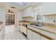 Open kitchen view featuring a skylight, white cabinets, and stainless steel sink at 10430 42Nd N St, Clearwater, FL 33762