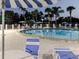 Relaxing community pool setting with comfortable seating, umbrellas, and a serene tropical ambiance at 10430 42Nd N St, Clearwater, FL 33762