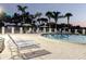 Inviting community pool with comfortable lounge chairs and tropical landscaping for relaxation and leisure at 10430 42Nd N St, Clearwater, FL 33762
