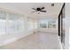 Sunroom features tile flooring, ceiling fan, and lots of windows providing natural light at 10430 42Nd N St, Clearwater, FL 33762