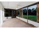 Enclosed sunroom with ceiling fan and views of green backyard through multiple windows at 10430 42Nd N St, Clearwater, FL 33762