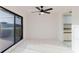 Bright sunroom with tile floor, ceiling fan, and sliding glass door leading to the outside at 10430 42Nd N St, Clearwater, FL 33762