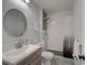 Updated bathroom with a modern sink, toilet, and walk-in shower with white subway tile at 106 E Cedar St, Tarpon Springs, FL 34689