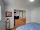 Bedroom featuring a wood dresser with a mirror and closet with wood floor at 106 E Cedar St, Tarpon Springs, FL 34689
