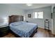 Comfortable bedroom featuring a window, wood floors, and a large bed with a blue patterned comforter at 106 E Cedar St, Tarpon Springs, FL 34689