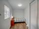 Cozy bedroom featuring a single bed, wood floors, and a window letting in natural light at 106 E Cedar St, Tarpon Springs, FL 34689