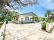 Exterior view of a charming blue and white home with a spacious driveway and well-maintained landscaping at 106 E Cedar St, Tarpon Springs, FL 34689
