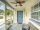 Charming front entrance with a cozy sitting area on the screened porch at 106 E Cedar St, Tarpon Springs, FL 34689