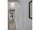 Bright hallway featuring light wood floors and an arched doorway leading to a blue front door at 106 E Cedar St, Tarpon Springs, FL 34689