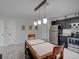 The kitchen features modern stainless steel appliances with overhead lighting above the dining area at 106 E Cedar St, Tarpon Springs, FL 34689