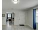 Bright room with an open floor plan leading to another room and featuring a door at 106 E Cedar St, Tarpon Springs, FL 34689