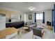 Living room features modern decor with updated kitchen and seating at 106 E Cedar St, Tarpon Springs, FL 34689