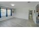Bright and spacious room features large windows, archways and modern tile flooring at 106 E Cedar St, Tarpon Springs, FL 34689