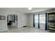 Bright room with an open floor plan featuring large windows, a door and modern tile flooring at 106 E Cedar St, Tarpon Springs, FL 34689