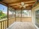 Relaxing screened patio with a ceiling fan, string lights and wooden deck overlooking the backyard at 106 E Cedar St, Tarpon Springs, FL 34689
