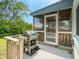 Relaxing screened patio with a grill, ceiling fan, and wooden deck overlooking the backyard at 106 E Cedar St, Tarpon Springs, FL 34689